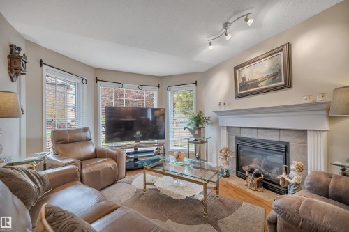 6 102 Bridgeport Crossing, Leduc, AB - Indoor Photo Showing Living Room With Fireplace