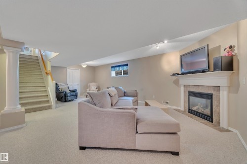 6 102 Bridgeport Crossing, Leduc, AB - Indoor Photo Showing Living Room With Fireplace
