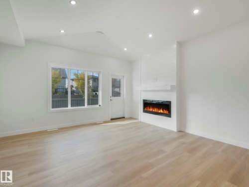 3138 Magpie Wy, Edmonton, AB - Indoor Photo Showing Living Room With Fireplace