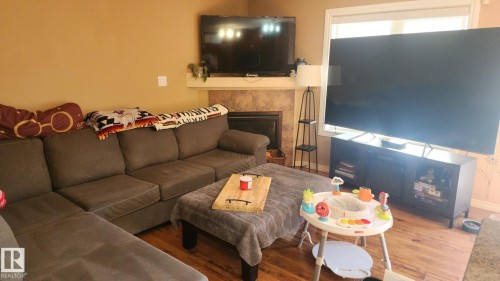 107 5420 Grant Macewan Boulevard, Leduc, AB - Indoor Photo Showing Living Room With Fireplace