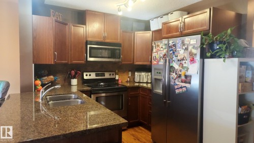 107 5420 Grant Macewan Boulevard, Leduc, AB - Indoor Photo Showing Kitchen With Double Sink