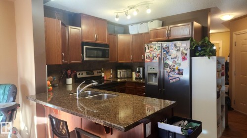 107 5420 Grant Macewan Boulevard, Leduc, AB - Indoor Photo Showing Kitchen With Double Sink