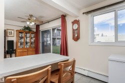 Dining area featuring a baseboard radiator, a textured ceiling, light tile patterned flooring, and a ceiling fan - 