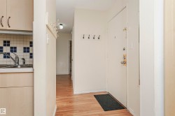 Hall with light wood-type flooring and a sink - 