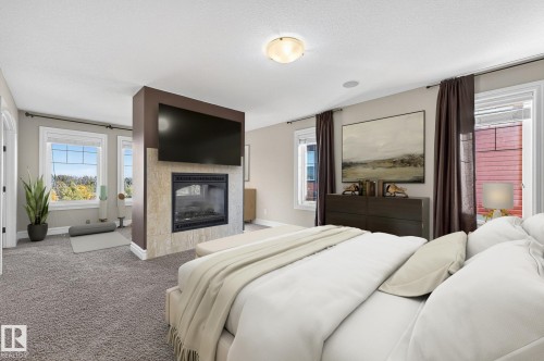 3841 Gallinger Loop, Edmonton, AB - Indoor Photo Showing Bedroom With Fireplace