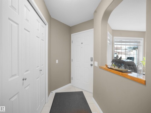 Doorway to outside featuring tile patterned floors and arched walkways - 94 Dechene Road, Edmonton, AB - Indoor Photo Showing Other Room