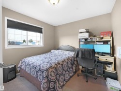Bedroom featuring carpet and a desk - 