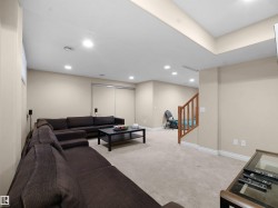 Living area featuring recessed lighting, light colored carpet, and stairway - 