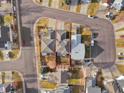 Aerial view of residential area featuring property parcel outlined - 