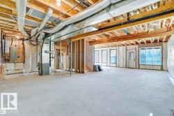 Below grade area featuring heating unit and electric panel - 