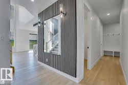 Hallway featuring stairs, light wood finished floors, and recessed lighting - 