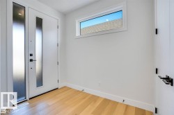 Foyer with light wood-type flooring and baseboards - 