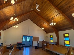 Recreation room with a chandelier, high vaulted ceiling, healthy amount of natural light, and wood ceiling - 