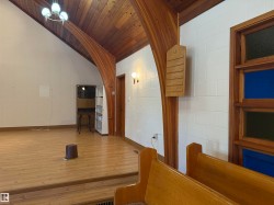 Corridor with wood finished floors, vaulted ceiling, and wooden ceiling - 