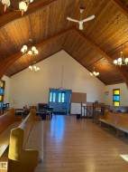 Playroom with a chandelier, high vaulted ceiling, a wood ceiling with exposed beams, and a ceiling fan - 