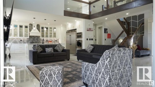 Living area with stairs, a towering ceiling, and recessed lighting - 707 180 Street, Edmonton, AB - Indoor