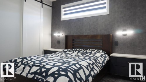 Bedroom with a barn door - 707 180 Street, Edmonton, AB - Indoor Photo Showing Bedroom