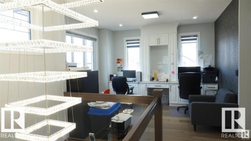 Office area with light wood-type flooring and healthy amount of natural light - 707 180 Street, Edmonton, AB - Indoor