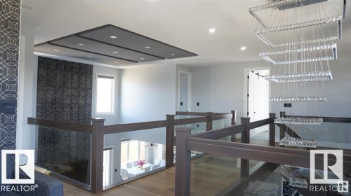 Hallway featuring an upstairs landing, recessed lighting, and wood finished floors - 707 180 Street, Edmonton, AB - Indoor Photo Showing Other Room