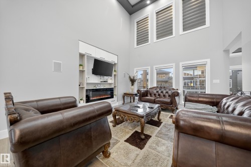 4406 Triomphe Close, Beaumont, AB - Indoor Photo Showing Living Room With Fireplace