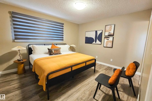Bedroom featuring a textured ceiling and wood finished floors - 4203 83 Street, Edmonton, AB - Indoor Photo Showing Bedroom