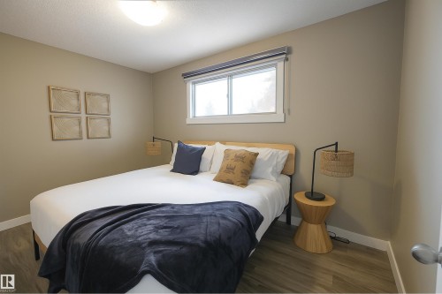 Bedroom with baseboards and dark wood-style flooring - 4203 83 Street, Edmonton, AB - Indoor Photo Showing Bedroom
