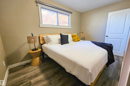 Bedroom with dark wood finished floors and a textured ceiling - 4203 83 Street, Edmonton, AB - Indoor Photo Showing Bedroom