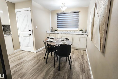 Dining room with light wood-type flooring - 4203 83 Street, Edmonton, AB - Indoor Photo Showing Other Room
