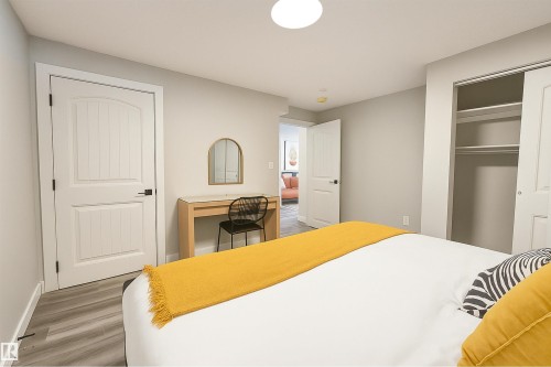 Bedroom with wood finished floors, a closet, and an office area - 4203 83 Street, Edmonton, AB - Indoor Photo Showing Bedroom