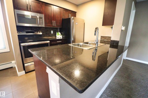 124 12025 22 Avenue, Edmonton, AB - Indoor Photo Showing Kitchen With Stainless Steel Kitchen With Double Sink With Upgraded Kitchen