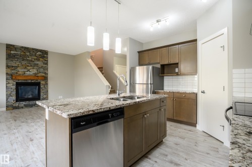 7298 Edgemont Way, Edmonton, AB - Indoor Photo Showing Kitchen With Fireplace With Double Sink