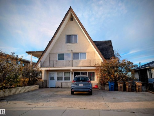 Rear view of property featuring a balcony and stucco siding - 10014 103 Ave, Lac La Biche, AB - Outdoor With Facade