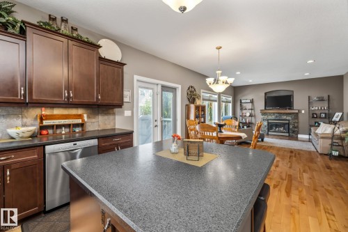 39 Hillside Terrace, Fort Saskatchewan, AB - Indoor Photo Showing Kitchen With Fireplace