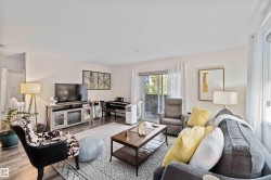 Living room with wood finished floors and a textured ceiling - 