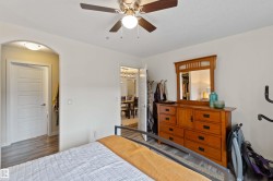 Bedroom with ceiling fan and wood finished floors - 
