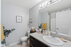 Bathroom featuring vanity, a textured ceiling, and curtained shower - 