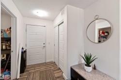 Entryway featuring wood finished floors and a textured ceiling - 