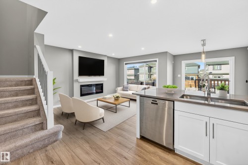 244 Larch Crescent, Leduc, AB - Indoor Photo Showing Kitchen With Fireplace