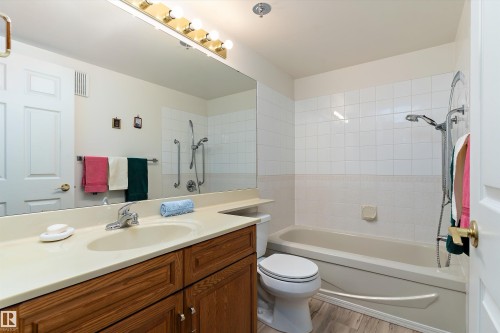 Full bathroom with vanity, shower / bathtub combination, and light wood-style flooring - 209 10915 21 Avenue, Edmonton, AB 