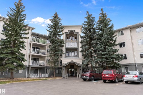 View of apartment building / complex with uncovered parking - 209 10915 21 Avenue, Edmonton, AB 