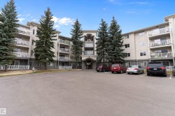 View of apartment building / complex with uncovered parking - 