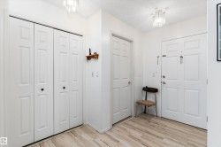Entryway featuring light wood-style flooring and a textured ceiling - 