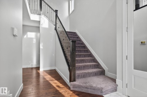 Stairs featuring wood-type flooring and a high ceiling - 8536 19 Avenue, Edmonton, AB - Indoor Photo Showing Other Room