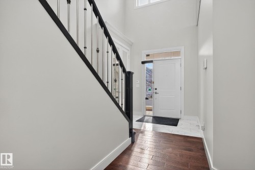 Entrance foyer with dark wood-type flooring, a high ceiling, and stairway - 8536 19 Avenue, Edmonton, AB - Indoor Photo Showing Other Room