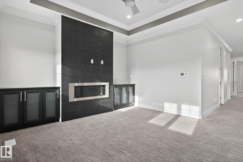 Unfurnished living room featuring crown molding, carpet, a large fireplace, recessed lighting, and a ceiling fan - 8536 19 Avenue, Edmonton, AB - Indoor Photo Showing Other Room With Fireplace
