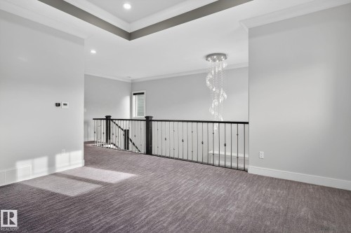 Empty room with crown molding, carpet flooring, recessed lighting, and a chandelier - 8536 19 Avenue, Edmonton, AB - Indoor Photo Showing Other Room