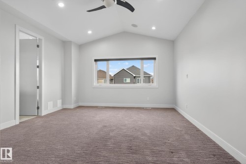 Spare room featuring light carpet, lofted ceiling, a ceiling fan, and recessed lighting - 8536 19 Avenue, Edmonton, AB - Indoor Photo Showing Other Room