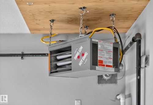 Detailed view of a heating unit and wood ceiling - 8536 19 Avenue, Edmonton, AB - Indoor Photo Showing Garage