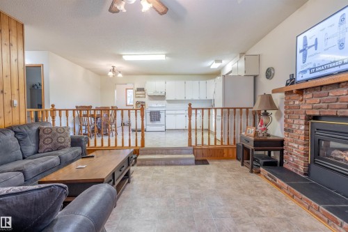 62 Buskmose Drive, Rural Wetaskiwin County, AB - Indoor Photo Showing Living Room With Fireplace
