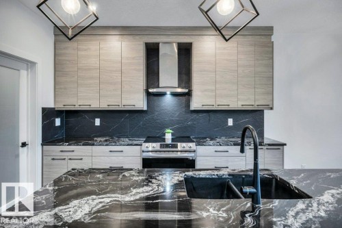 560 Stout Bend, Leduc, AB - Indoor Photo Showing Kitchen With Double Sink With Upgraded Kitchen